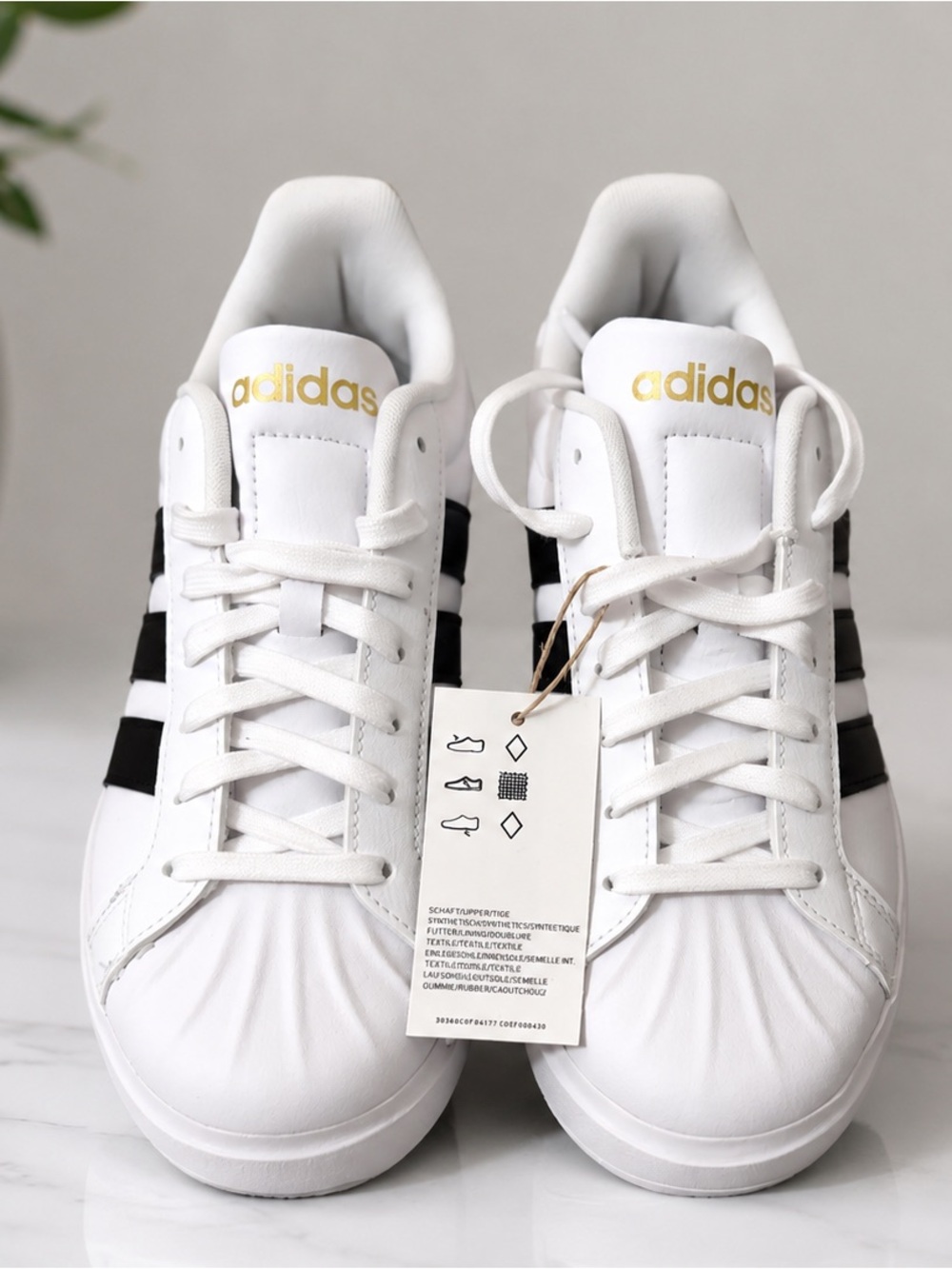 adidas White Superstar Sneakers with Black Stripes and Gold Logo